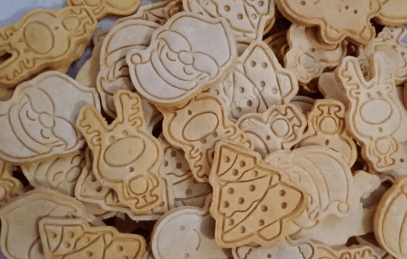 Banana pet biscuits in festive Christmas shapes with embossed designs.