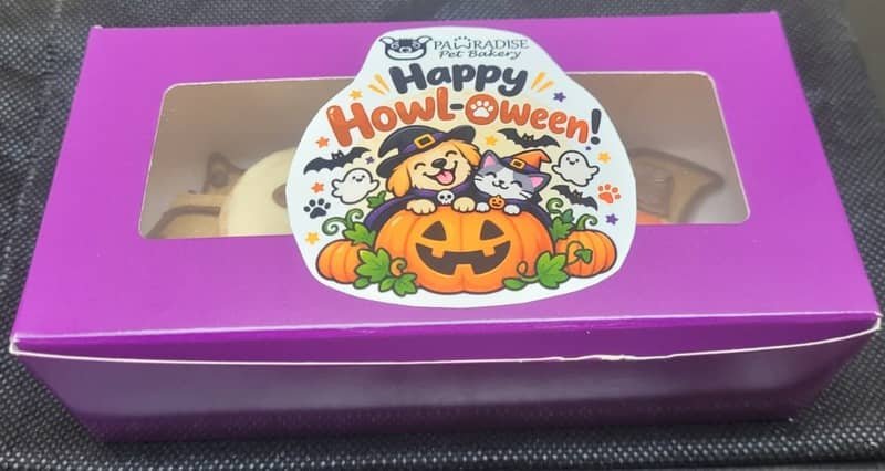 Pawradise Pet Bakery Halloween treat box in purple packaging with a festive “Happy Howl-o-ween!” label.