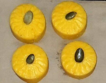 Pet pedas made with dairy and honey, topped with pumpkin seeds and arranged on a baking tray.